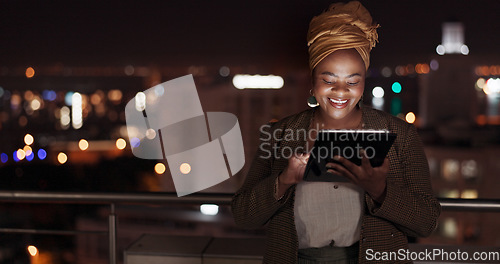 Image of Tablet, night and balcony with a business black woman doing research online while standing outdoor at her office. Working late, search and deadlines with a female employee doing overtime at work