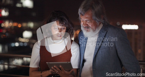 Image of Business team, tablet and night on city building rooftop talking global networking, digital marketing and social media. Man and woman with 5g network on mobile stock market app for innovation idea