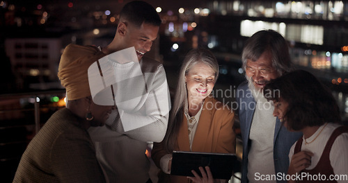 Image of Tablet, collaboration and night with a business team working together in the city on their office balcony. Finance, teamwork and meeting with a man and woman employee group talking strategy outside