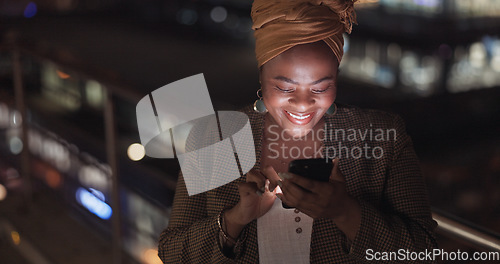 Image of City, rooftop and black woman on a phone at night networking on social media or the internet. Technology, happiness and African lady browsing online with a cellphone on an outdoor balcony in a town.