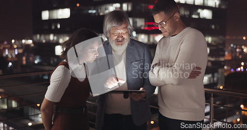 Image of Business team, tablet and night on city building rooftop talking global networking, digital marketing and social media. Man and woman with 5g network on mobile stock market app for innovation idea