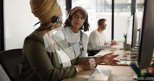 Image of Call center, training and black woman coaching recruit at customer service agency in Africa. Diversity, teamwork and crm, telemarketing manager consulting woman at desk for customer support help line