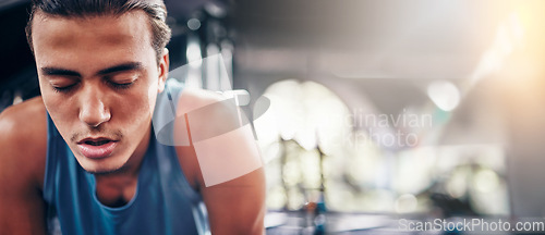 Image of Tired, man and gym for fitness, workout and intense training against bokeh background space. Exercise, break and athletic male stop for breathing, rest and exhausted from cardio, sports or challenge