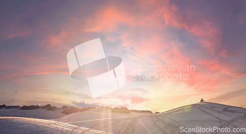 Image of Sunset, desert and athlete riding a motorbike for extreme sports training, exercise or competition. Fitness, evening and man driving a motorcycle for a race or workout with a sand dune landscape.