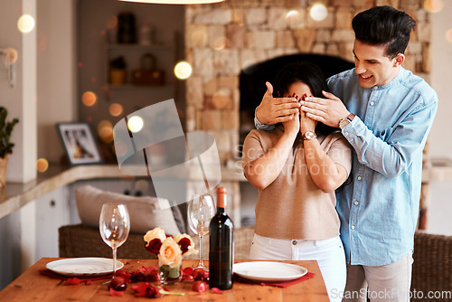 Image of Couple surprise, romantic home dinner and man cover womans eyes for fine dining, red wine or Valentines day date. Marriage anniversary love, rose petals and happy people celebrate holiday event