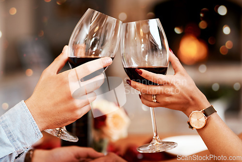 Image of Red wine, glass and couple hands toast, celebrate or cheers in 5 star restaurant or fine dining alcohol store. Romance love, marriage anniversary or people on Valentines Day date for holiday event