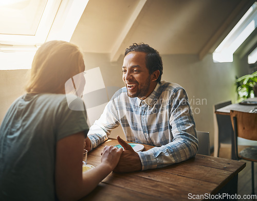 Image of Valentines couple, love and holding hands at restaurant on table, talking and laughing at joke. Comic, romance diversity and affection of man and woman on date, having fun and enjoying quality time.