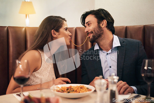 Image of Love, happy and spaghetti with couple in restaurant sharing for romance, valentines day and date. Bonding, smile and celebration with man and woman with pasta at table for fine dining, wine and cute