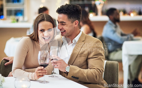 Image of Love, wine and happy couple at a restaurant for valentines day, celebration and bonding while laughing. Alcohol, fine dining and woman with funny man on first date, anniversary or birthday dinner