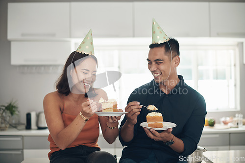 Image of Birthday, cake and couple in a kitchen for celebration, happy and bonding in their home, smile and laughing. Party, people and man with woman on a counter for eating, fun and celebrating in Japan