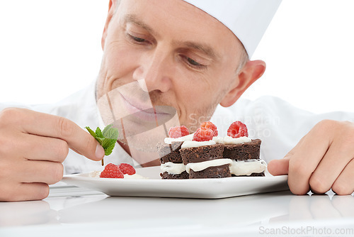 Image of Dessert, plate and chef in a studio cooking with mint for a sweet treat, snack or craving. Culinary, food industry and man baker baking a delicious cake with fruit while isolated by white background.