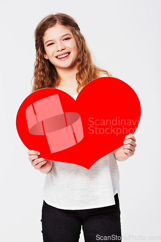 Image of Red heart, love and portrait of girl in studio for peace, self love and affection on white background. Shape, emoji and face of teenager holding cardboard sign, loving and gesture with mockup