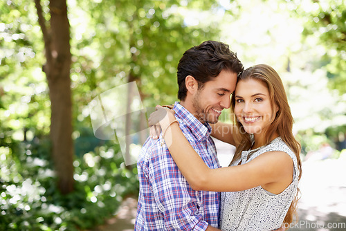 Image of Portrait, hug and couple in a park for date, valentines day and bonding while embracing against a blurred background. Face, love and man hugging woman in nature, excited or romantic outside in Mexico