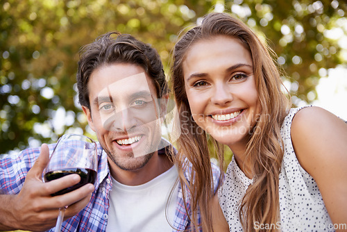 Image of Love couple, portrait or wine on picnic, valentines day or romance date bonding in nature park or garden low angle. Smile, happy woman or man and alcohol drinks glass in marriage anniversary security