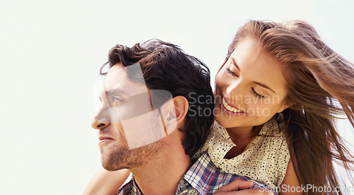 Image of Couple, smile or piggyback on love, valentines day or romance date in park bonding, garden or nature. Happy, man and carrying woman in fun game, freedom security or energy support on sky background