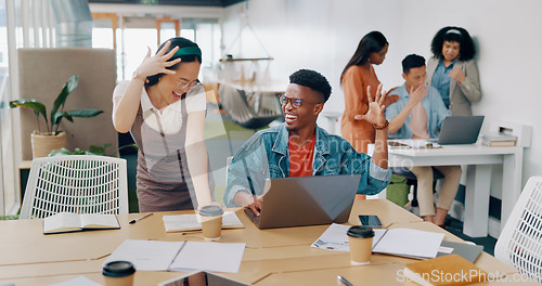 Image of Teamwork, laptop and business people fist bump in office for success celebration. Training, coaching and Asian woman teaching black man, support and advice while celebrating after solving problem.