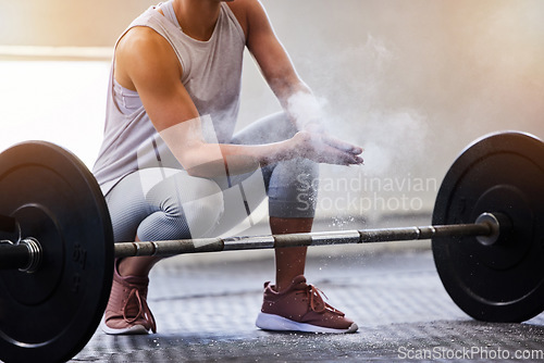 Image of Hands, weightlifting and powder with a woman bodybuilder getting ready to exercise or workout at gym. Fitness, grip and training with a female weight lifter bodybuilding for strong muscles or health