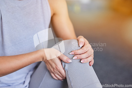 Image of Knee injury, woman hands and workout legs massage of a athlete in pain from training in a gym. Sports, exercise and workout leg accident in a health and wellness center with blurred background