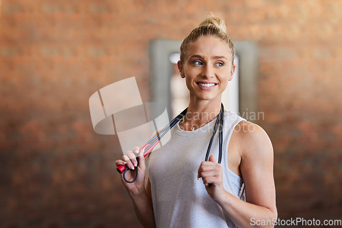 Image of Jump rope, gym and woman thinking with sport equipment ready for exercise and workout. Fitness motivation, training and healthy sports of an athlete at a health and wellness center with a smile