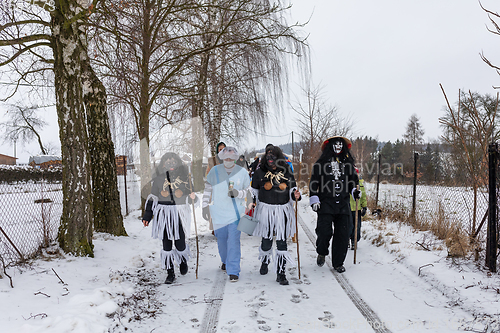 Image of Peoples in mask attend Masopust or the Mardi Gras carnival, traditional ceremonial door-to-door procession. 