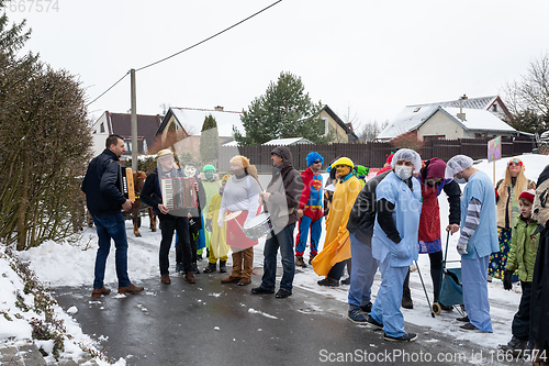 Image of Peoples in mask attend Masopust or the Mardi Gras carnival, traditional ceremonial door-to-door procession. 