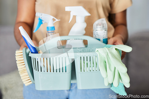 Image of Cleaning, supplies and basket in the hands of a woman housekeeper for domestic hygiene or sanitizing. Covid, service and housekeeping with a female cleaner holding a container of disinfectant