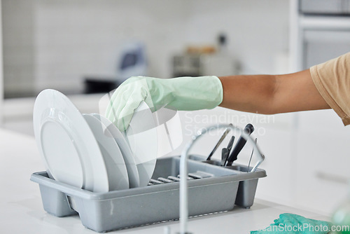 Image of Woman hand, plate dishes and sink in kitchen for washing, cleaning and hygiene in house chores with gloves. Cleaner lady, hand and home for clean, stop bacteria and service for wellness in apartment