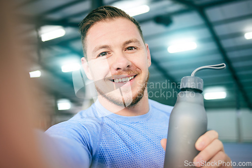 Image of Fitness, selfie and portrait of man with water bottle at gym for training, exercise and cardio on blurred background. Face, athletic and guy smile for photo while relax with drink during body workout