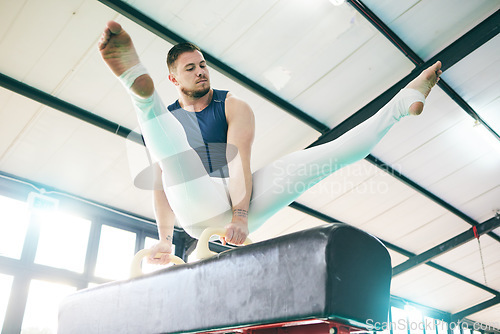 Image of Fitness, gymnastics and man on a balance beam for training, cardio and strength at gym. Athletic, male and acrobat practice speed, control and sport routine for muscle, power or endurance performance