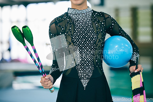 Image of Rhythmic gymnast, dancer and gymnastic equipment in a gym for a performance exercise. Fitness, girl training and sequin dance suit of a artist with a sport ball for a competition in a sports gym