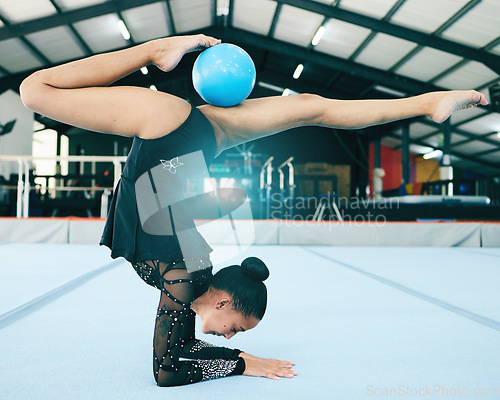 Image of Balance, gymnastics and woman stretching with a ball for a competition, practice or training. Fitness, sports and female athlete gymnast doing a flexibility, agility and endurance exercise in a gym.