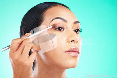 Image of Woman, hand and face in beauty makeup, skincare or self love and care isolated against a studio background. Female hands applying eyeshadow or product with brush in cosmetics for facial treatment