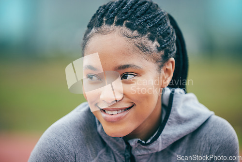 Image of Black woman, athlete smile and face zoom of a young person ready for field running. Sport, happiness and motivation of a runner athlete outdoor with blurred background on a fitness and workout break