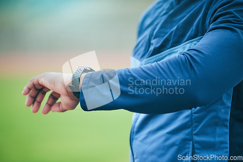 Image of Time, watch and hand of a fitness man watching fitness, run and training results on a smartwatch. Workout tech, sports and exercise app monitor outdoor with an athlete with blurred background