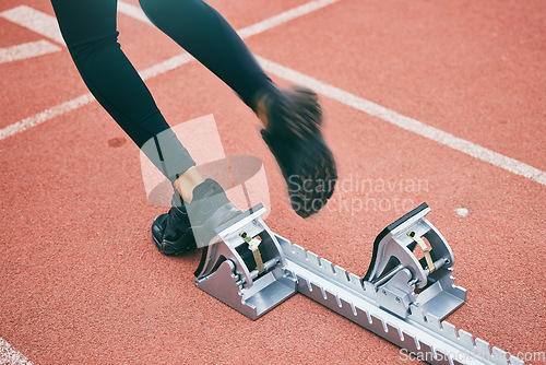 Image of Feet, running and race start blocks with woman athlete on stadium, motion blur and speed, action and fitness outdoor. Training, runner sneakers and sports training with exercise and cardio on track