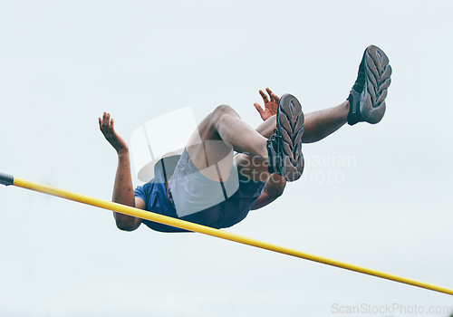 Image of Fitness, athletics high jump by man at a stadium for training, energy and cardio against sky background. Jumping, athlete and male outdoors for performance, endurance and competition on mock up