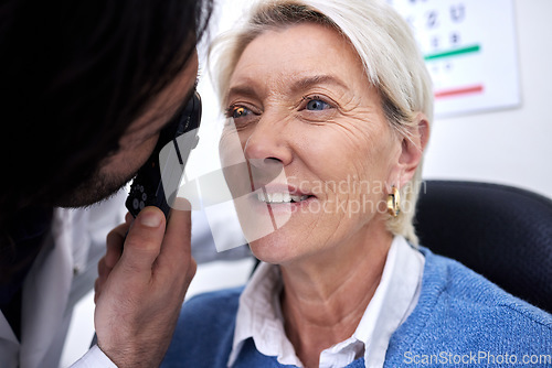 Image of Optometry, eye check and woman with an optician for healthcare, consultation and vision exam. Lens test, health and senior patient with a male ophthalmologist with a light to look at visual problem