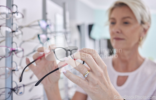 Image of Senior woman, glasses and shopping for lens or frame for eye care, vision and wellness with optometry. Customer person making choice or decision for retail sale with health insurance at optics store