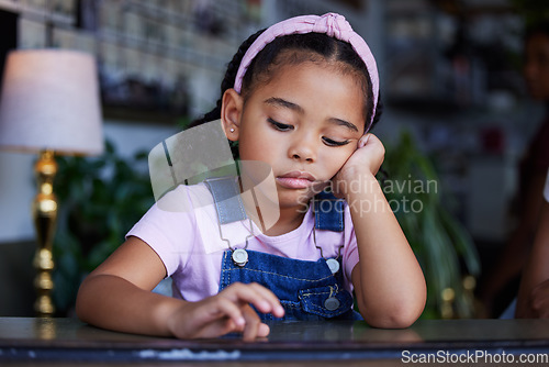 Image of Sad, bored and lonely kid in home, depressed or upset while thinking alone in house. Loneliness, depression and anxiety, stress or mental health of disappointed girl with negative facial expression.