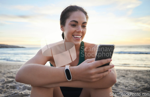 Image of Beach, relax and happy woman on a phone browsing on the internet, online or a mobile app. Happiness, smile and female networking or scrolling on social media with a cellphone by the ocean at sunset.