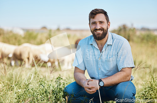 Image of Portrait, farmer and man on field, sheep or smile for growth, production or in nature or sustainability. Face, male or business owner countryside, food industry or farming livestock for sale or happy