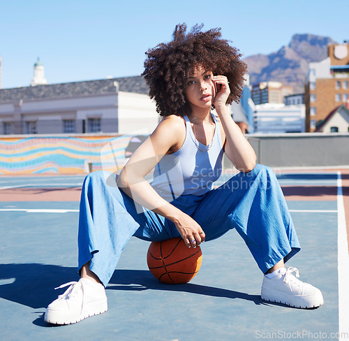 Image of Basketball, fashion and portrait of black woman on court floor with trendy, urban style and edgy clothes in city. Sports, fitness and girl model outdoors with ball for freedom, energy and cool outfit