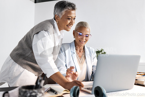 Image of Laptop, collaboration and support with a woman manager training an employee in the office at work. Computer, teamwork and help with a female coach or supervisor at an employee desk for assistance