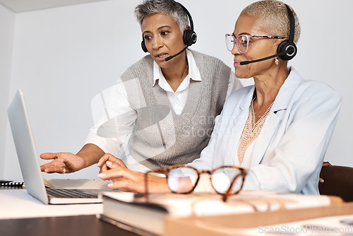 Image of Call center, customer support and manager training a consultant by doing a consultation together online. Crm, sales and professional senior leader helping a female agent on a laptop in the office.