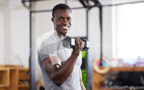 Image of Strong, weight and portrait of a black man lifting for muscle, training and power in the gym. Smile, fitness and African athlete doing a workout, exercise or sports for body building and cardio