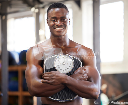 Image of Black man, bodybuilder and gym for portrait with weight scale for muscle growth, power and wellness. Happy fitness person with training, workout or exercise motivation for goals, body and health