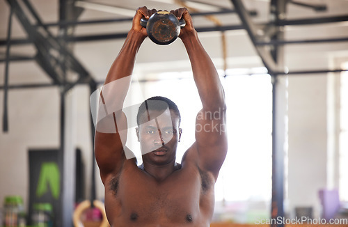 Image of Black man with kettlebell in gym, fitness and portrait with arm muscle training, bodybuilder and weightlifting exercise. Biceps, strong and bodybuilding, focus and serious with commitment to workout