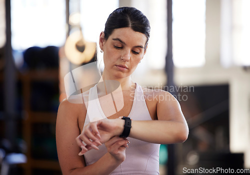 Image of Fitness, smartwatch and woman in gym for training, workout or exercise results, monitor or progress update, Check, timer and goals of athlete or sports person with technology for health and wellness