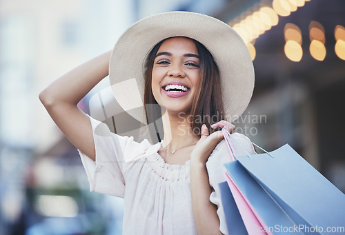 Image of Woman, shopping and portrait smile in the city carrying bags for discount, deal or purchase. Happy female shopper smiling in joyful happiness for luxury, fashion gifts or sale in an urban town