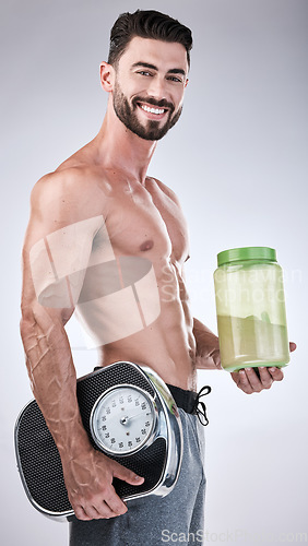 Image of Protein shake, fitness and scale with portrait of man for workout, muscle and weight loss. Diet, gym and training with athlete and powder for sports, exercise and nutrition in gray studio background